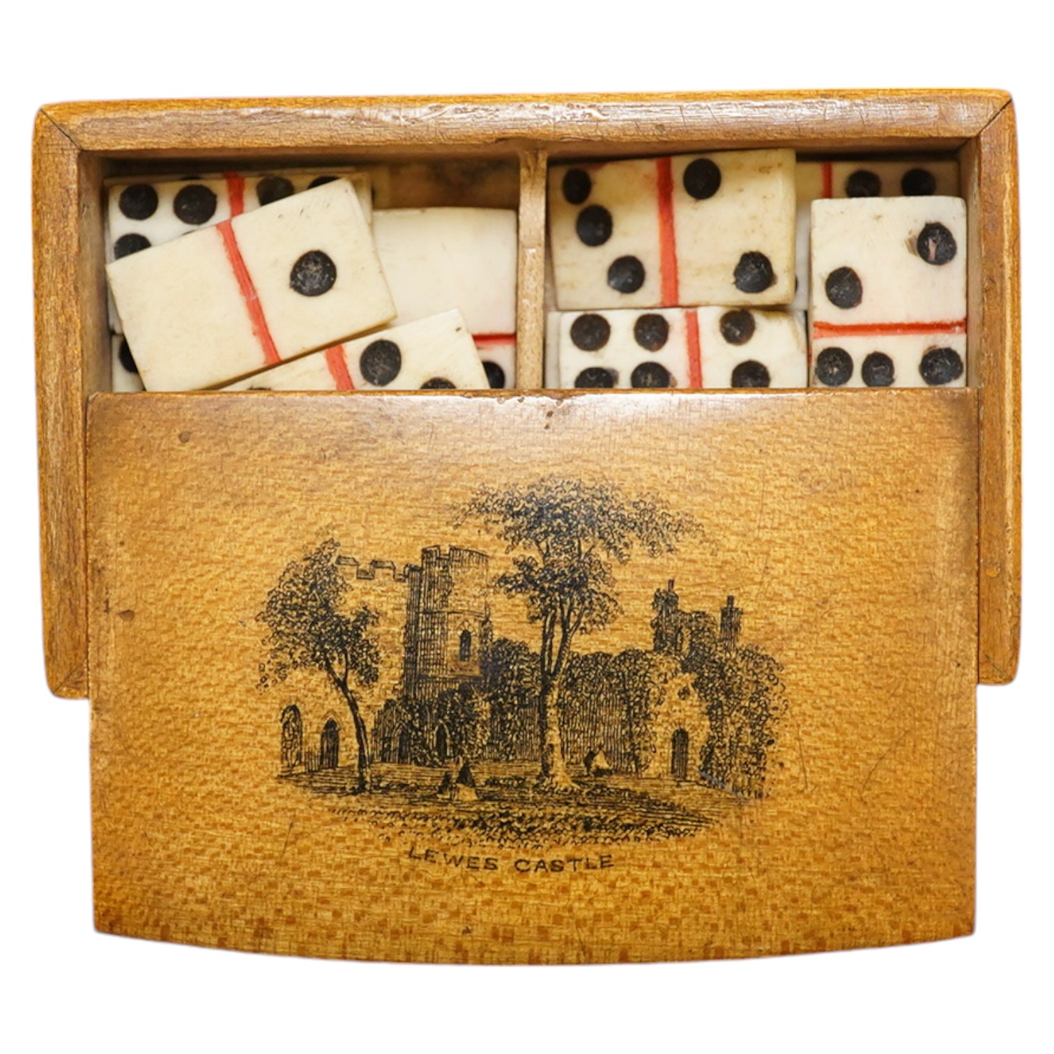 A Mauchline ware ‘Lewes Castle’ box containing a full set of bone dominoes, 5cm. Condition - fair to good